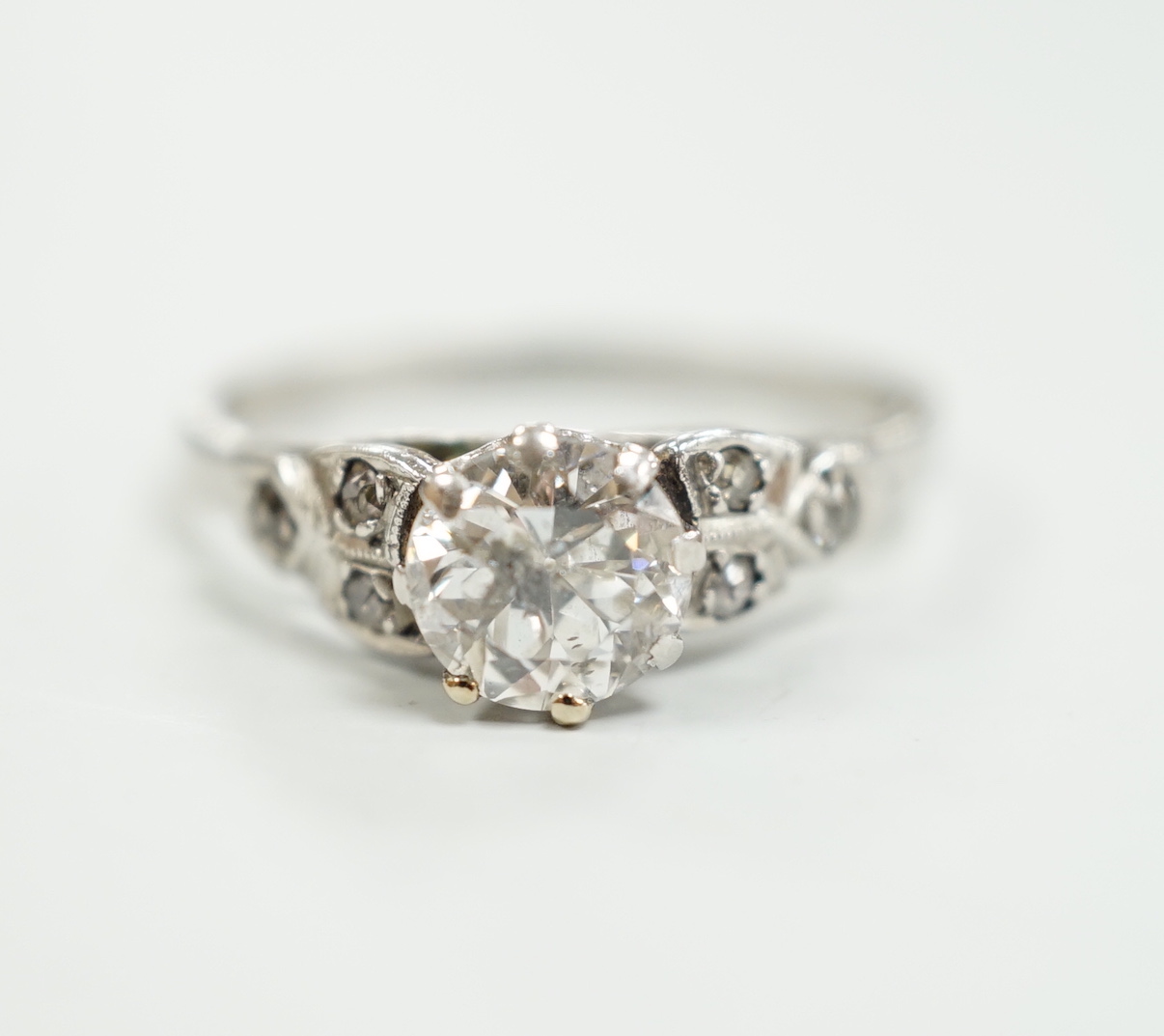 A white metal, stamped plat and single stone diamond ring, with diamond set shoulders, size O, gross weight 3.2 grams
